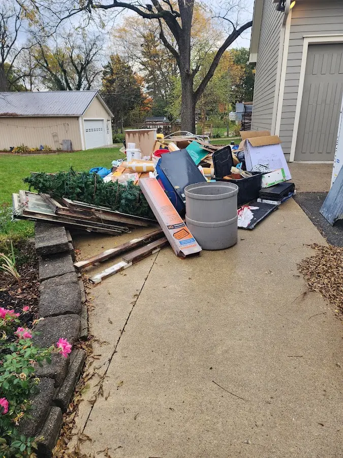 Dumpster being loaded with debris for Estate Cleanout Dumpster Rental in West Athens